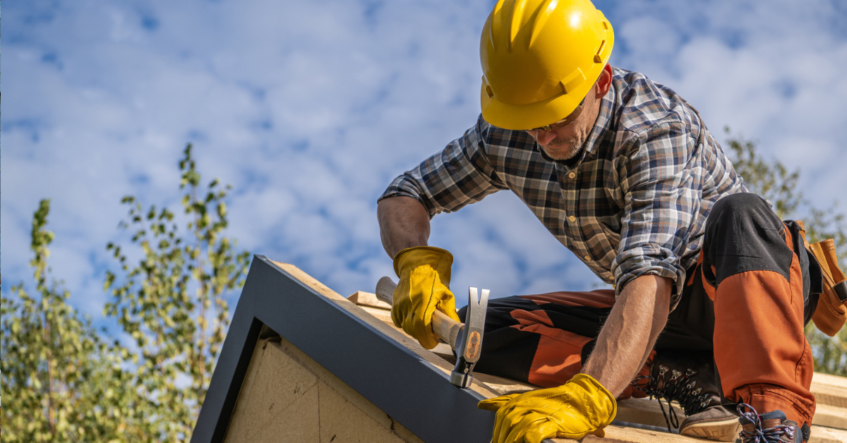 A skilled roofer working on a roof—finding a good roofing company like this takes effort, but our tips help you choose the best.